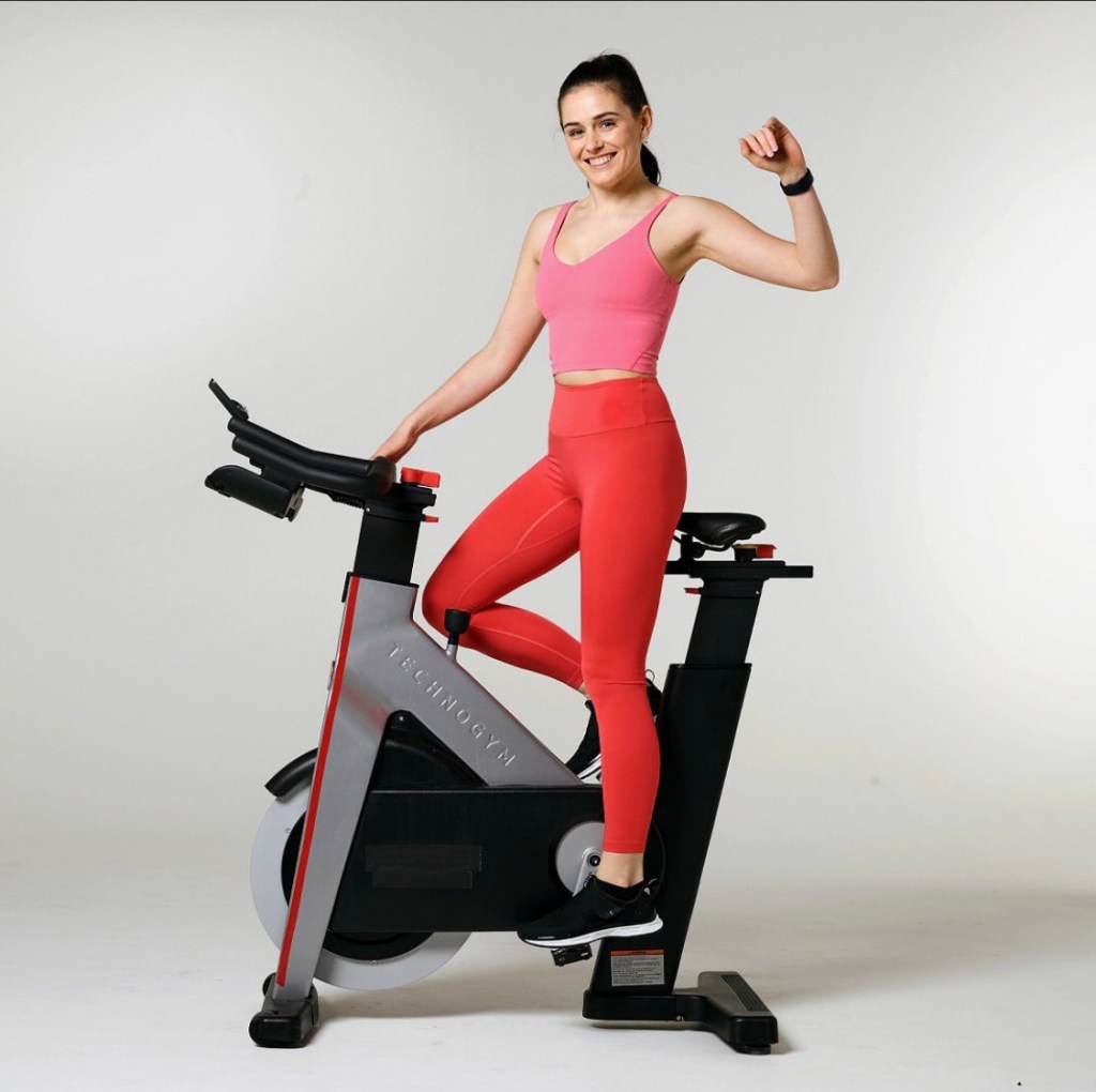 A fun an energetic image of an instructor on a spinn bike for a Virgin Active campaign. This is a very posed studio shoot where the instructor is standing upright on the bike, eyes to camera with one hand in the hair.